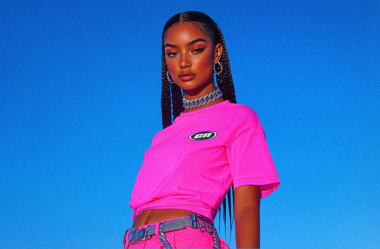 Model showcasing Club Neo's vibrant pink streetwear t-shirt against a clear blue sky.