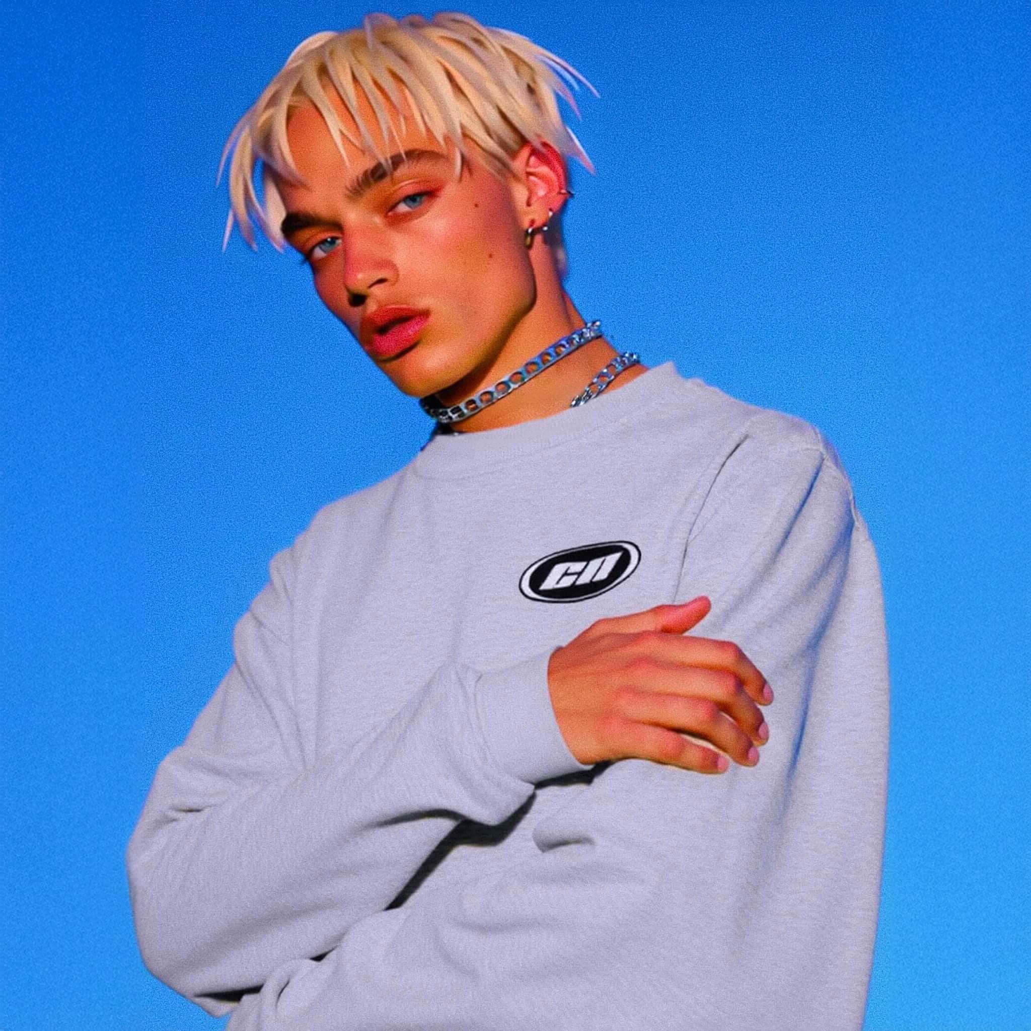 Person wearing a light gray sweatshirt with a logo on a blue background
