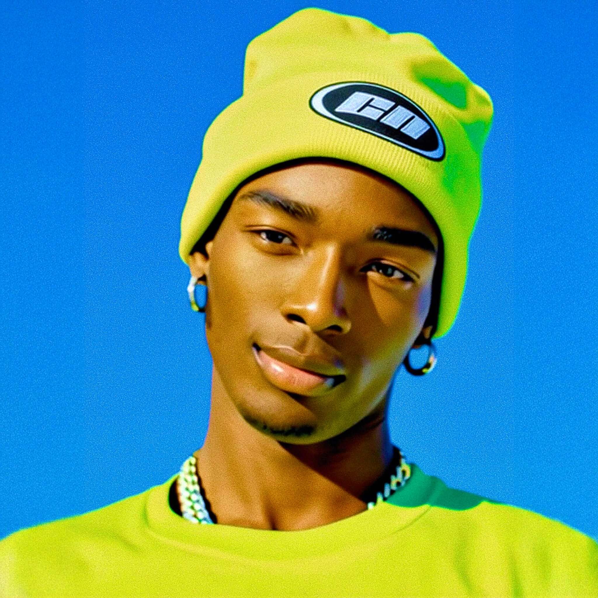 Person wearing a bright yellow beanie and shirt against a blue background