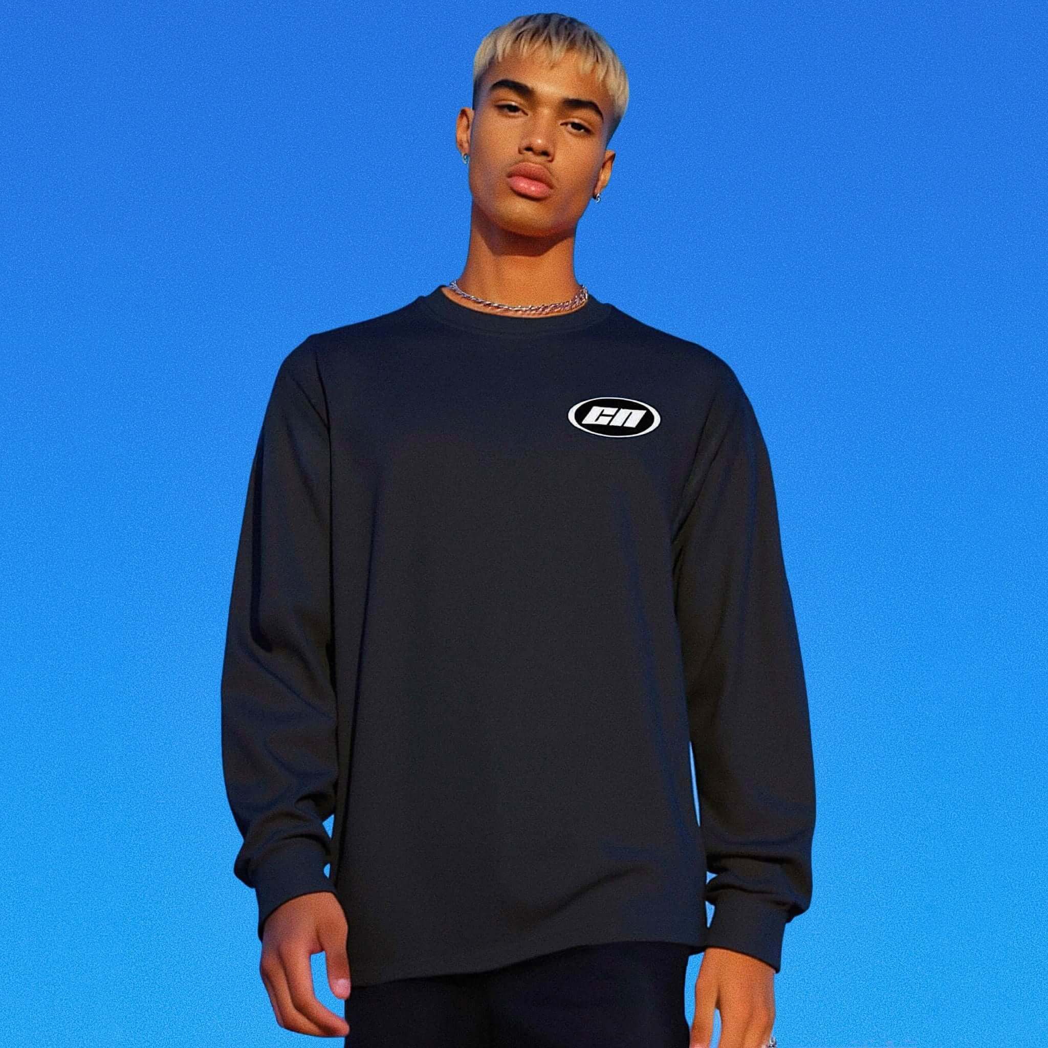Person wearing a black long-sleeve shirt with a logo on a blue background