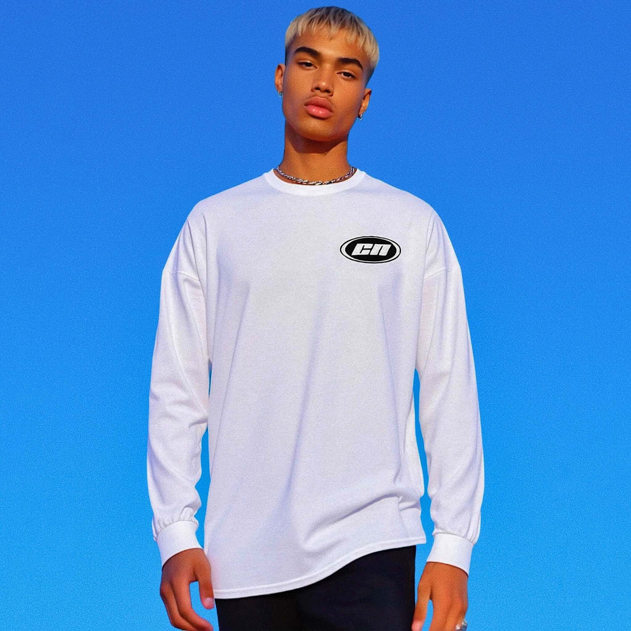 Person wearing a white long-sleeve shirt with a logo against a blue background