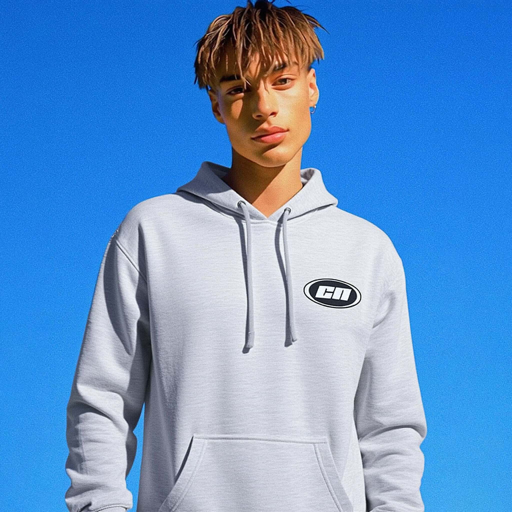 Person wearing a gray hoodie with a logo against a blue sky