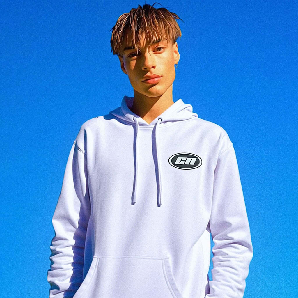 Person wearing a white hoodie with a logo against a clear blue sky